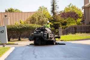 Buggy laying down sealcoat for Balboa Park