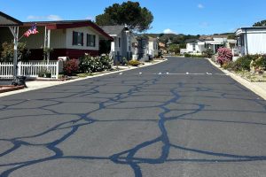Multiple sealed cracks across a large HOA pavement area