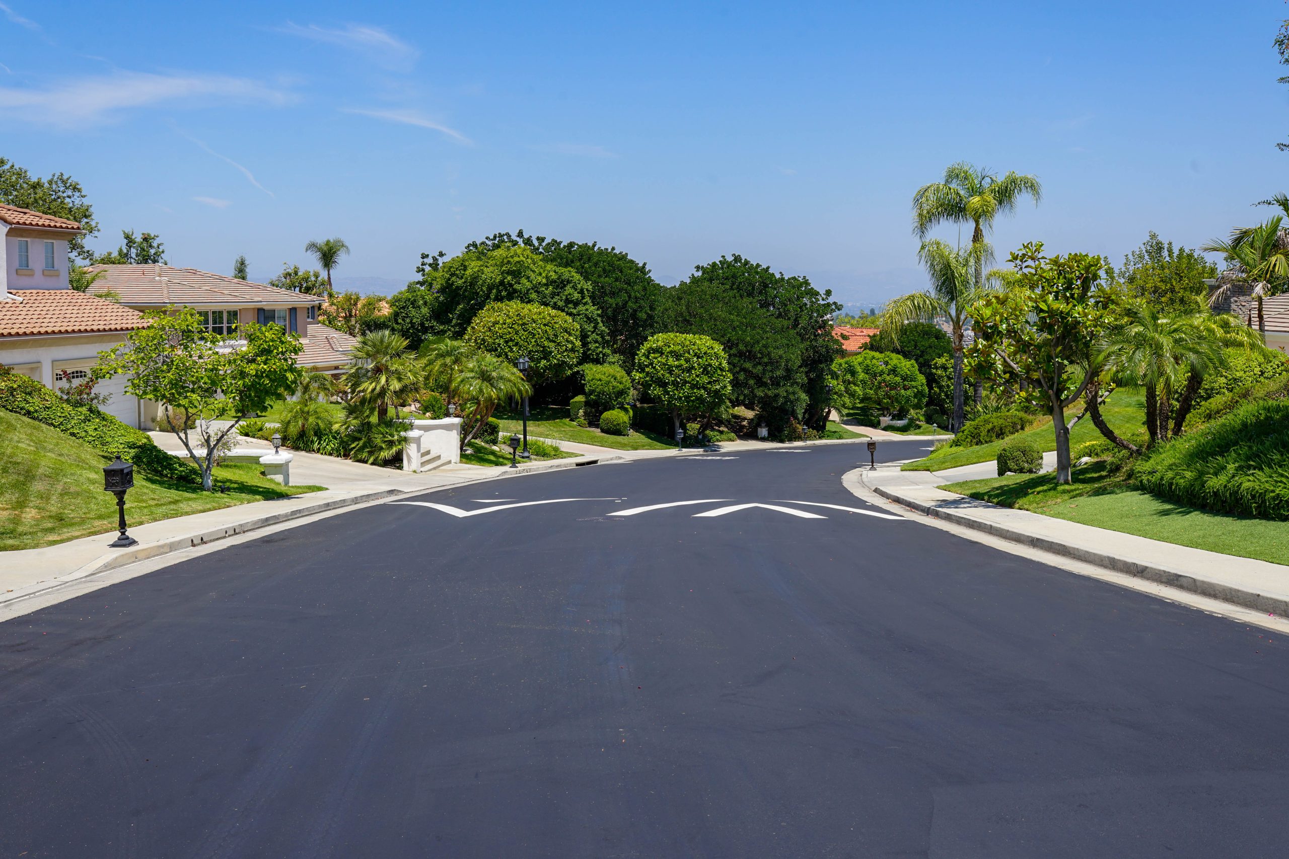 Freshly sealcoated HOA road in Tarzana with new speed bump pavement markings